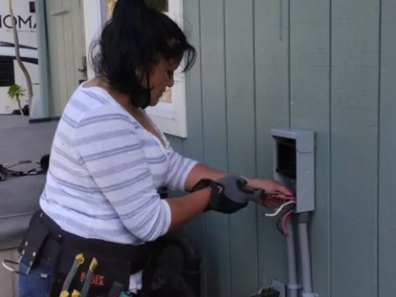 Licensed electrician wiring an exterior subpanel in Willoughby